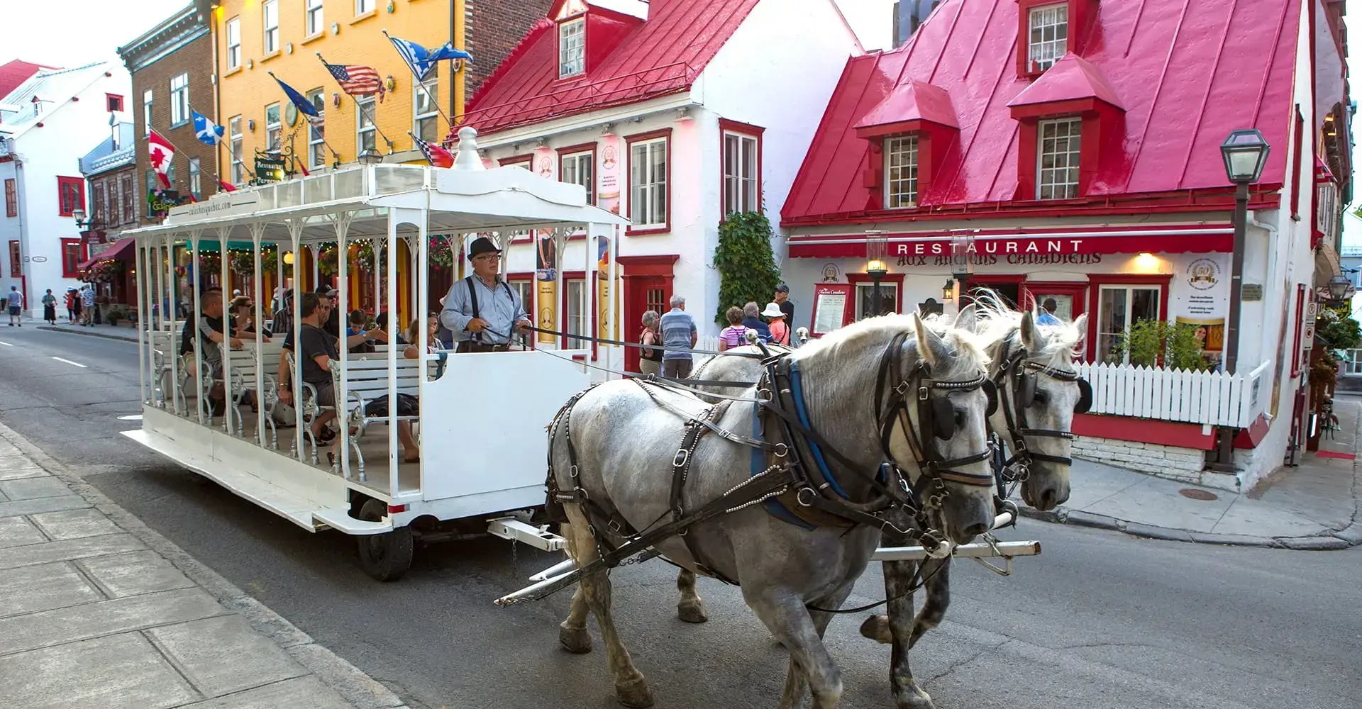 A Calèches Québec horse-drawn tramway carrying visitors along Saint-Louis Street in Old Québec.