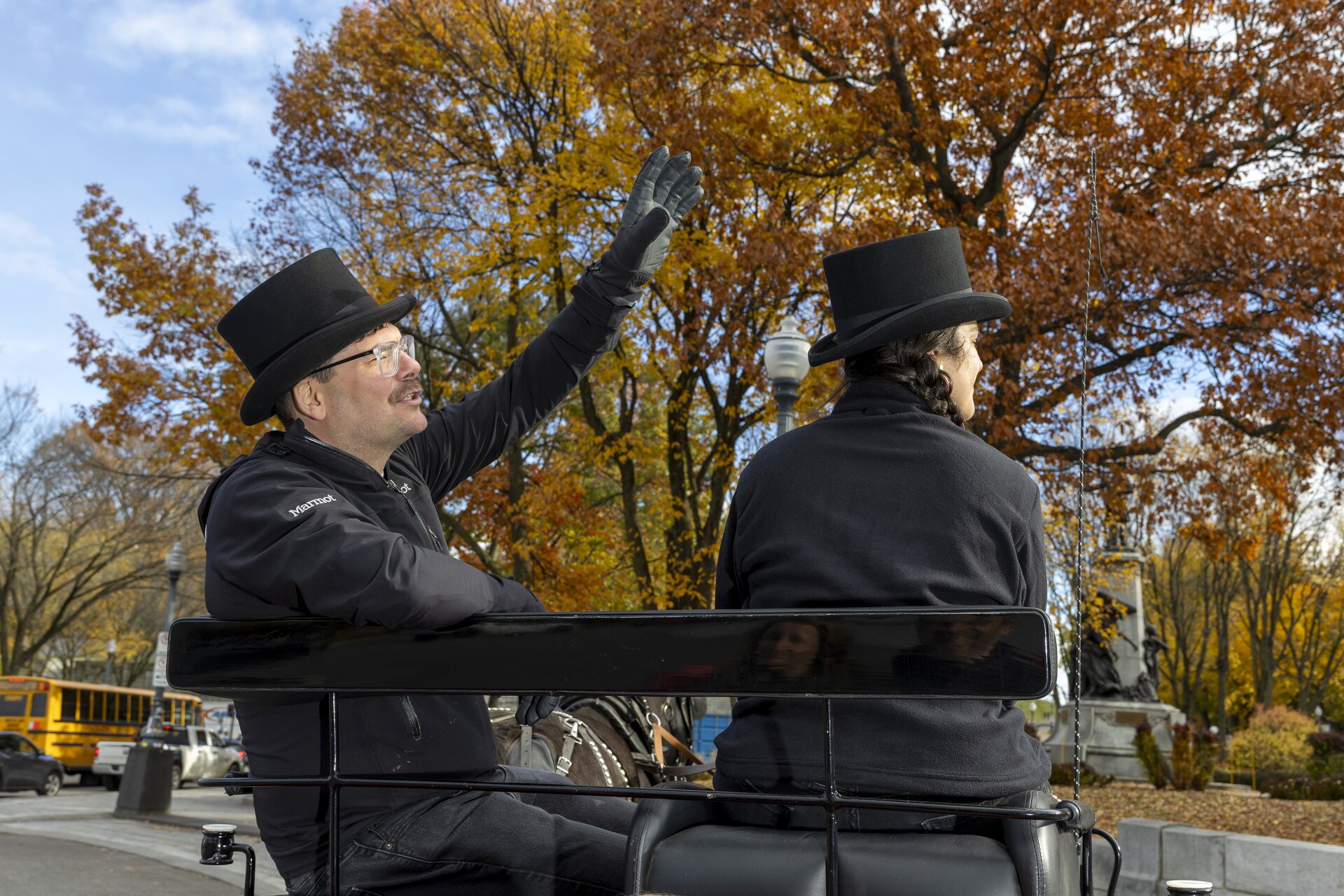 A guide pointing out a landmark beside the carriage driver in Old Québec.